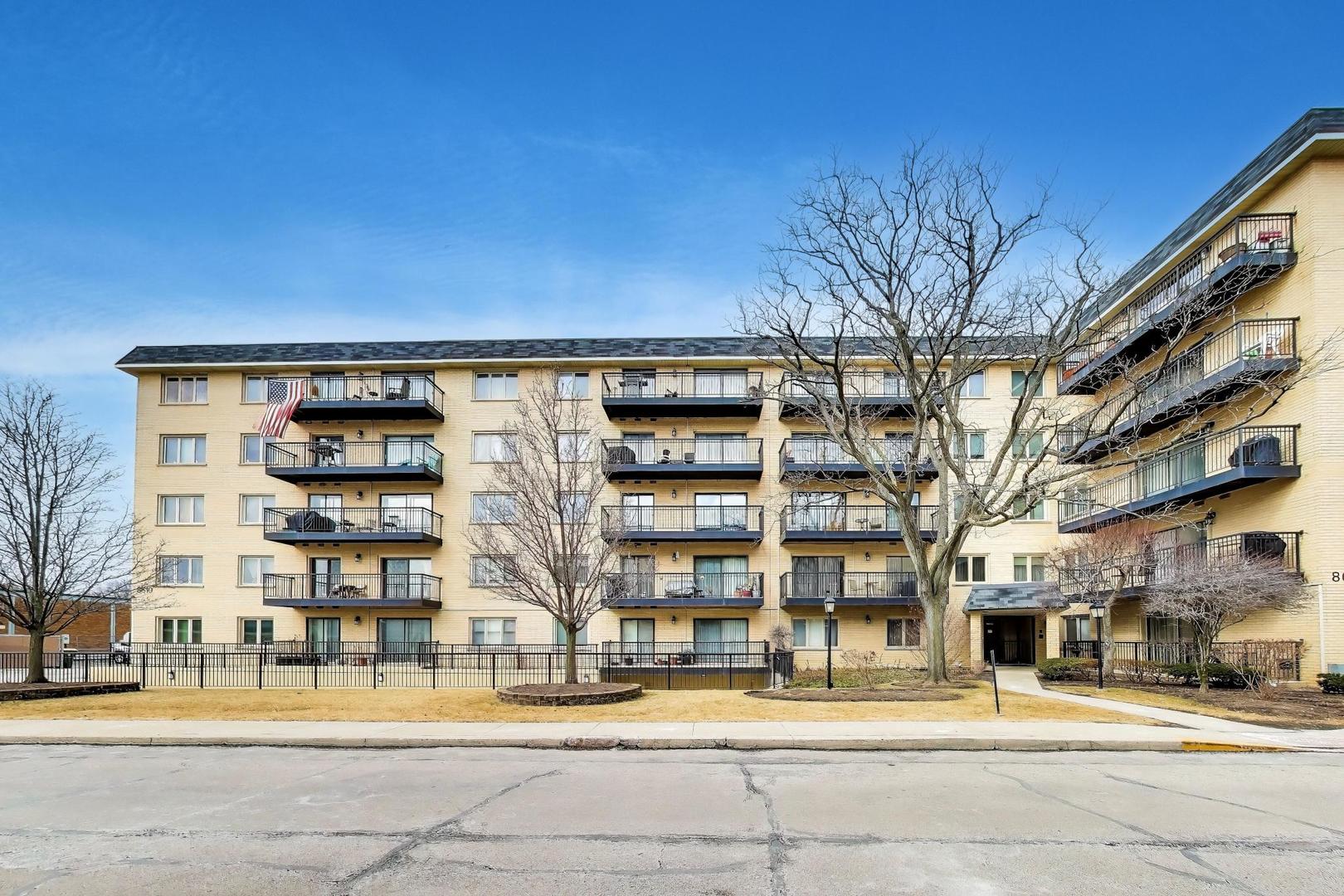 8610 Waukegan Road, Unit 302 Morton Grove, IL 60053 - Photo 33 of 34 a front view of a building with a garden
