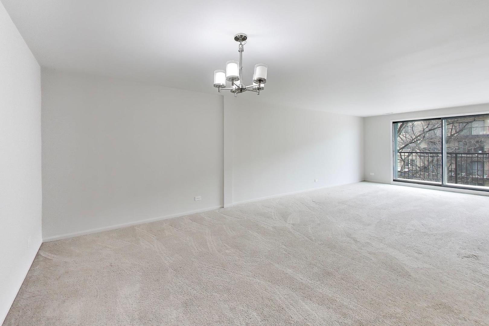 8610 Waukegan Road, Unit 302 Morton Grove, IL 60053 - Photo 6 of 34 a view of an empty room with a window