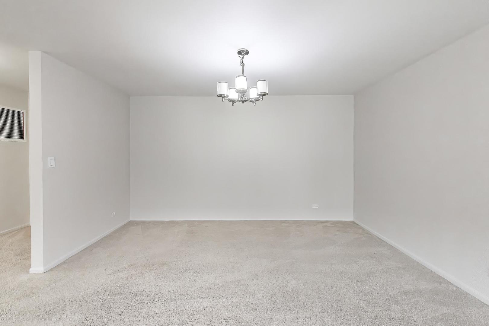 8610 Waukegan Road, Unit 302 Morton Grove, IL 60053 - Photo 9 of 34 a view of an empty room with a window