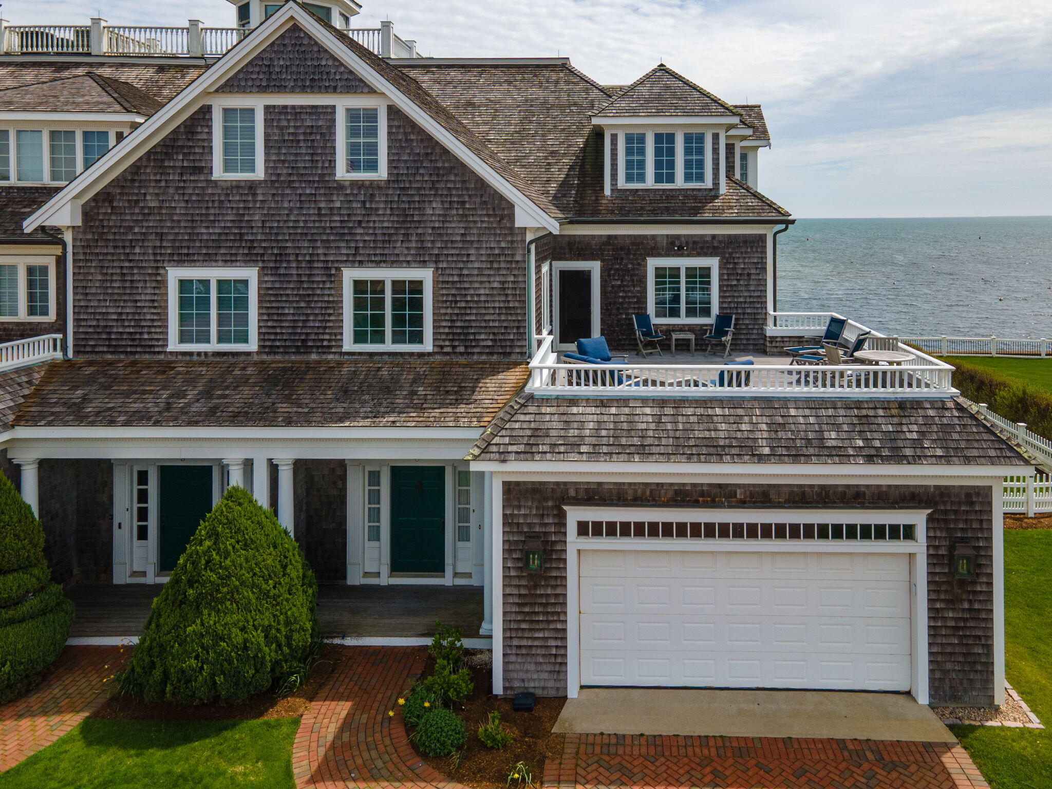 23 Snow Inn Road, Unit 8 Harwich Port, MA 02646 - Photo 2 of 100 a view of a house with a yard and potted plants
