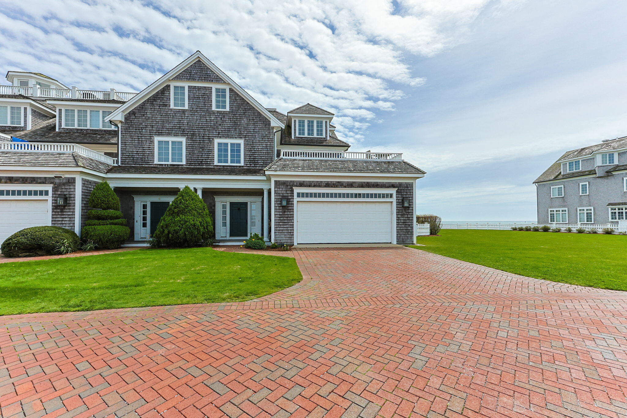 23 Snow Inn Road, Unit 8 Harwich Port, MA 02646 - Photo 5 of 100 a front view of a house with a yard and garage