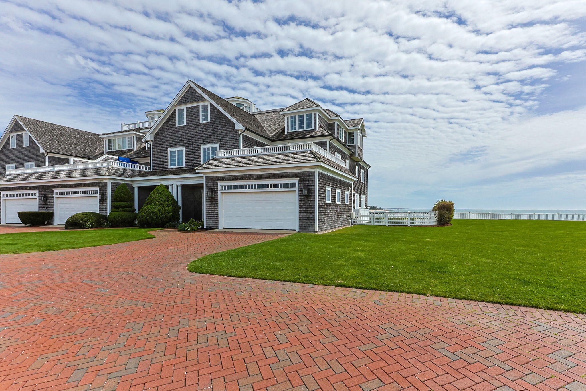 23 Snow Inn Road, Unit 8 Harwich Port, MA 02646 - Photo 6 of 100 a front view of a house with a yard and garage