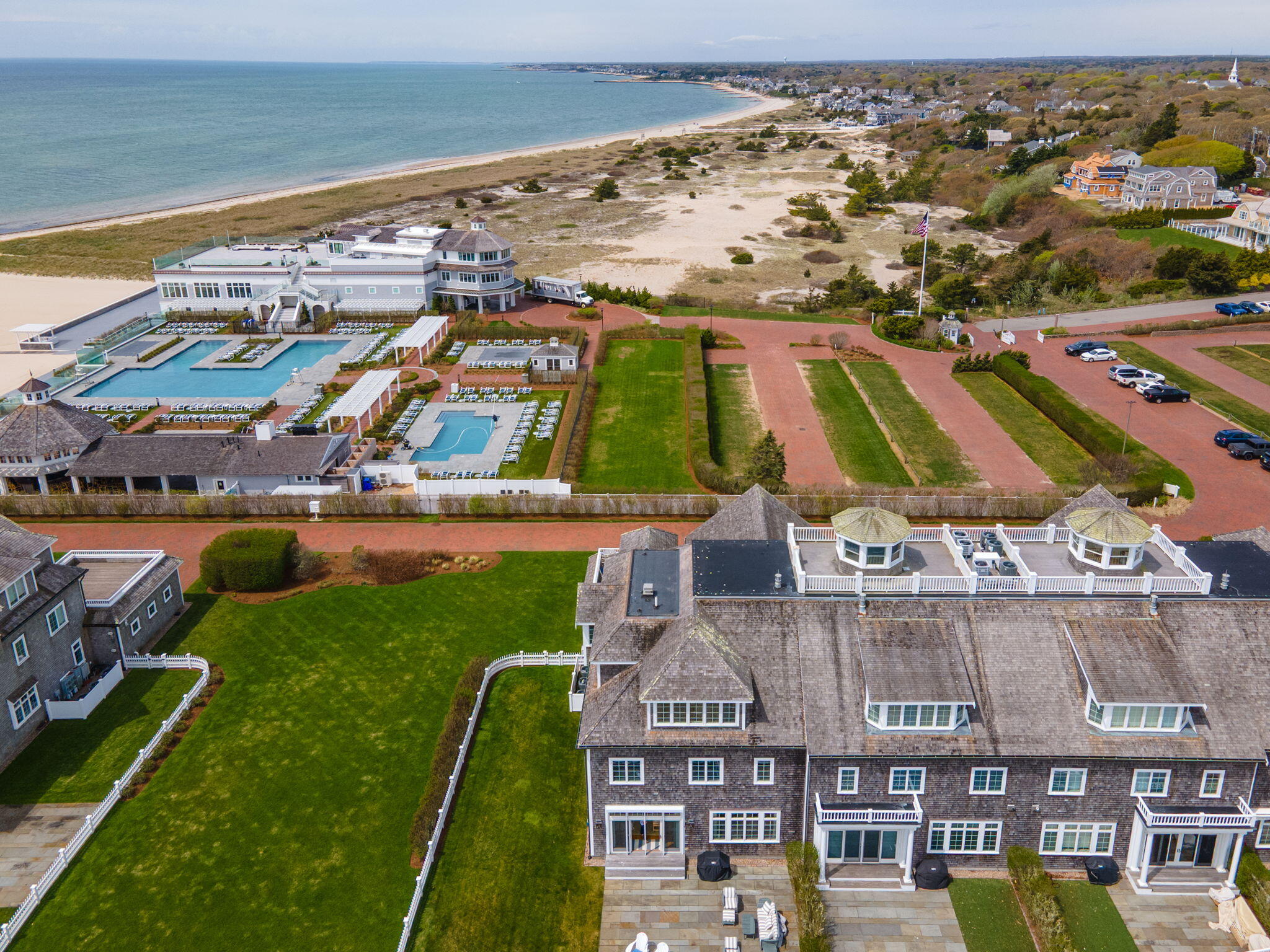 23 Snow Inn Road, Unit 8 Harwich Port, MA 02646 - Photo 89 of 100 an aerial view of residential houses with outdoor space and swimming pool