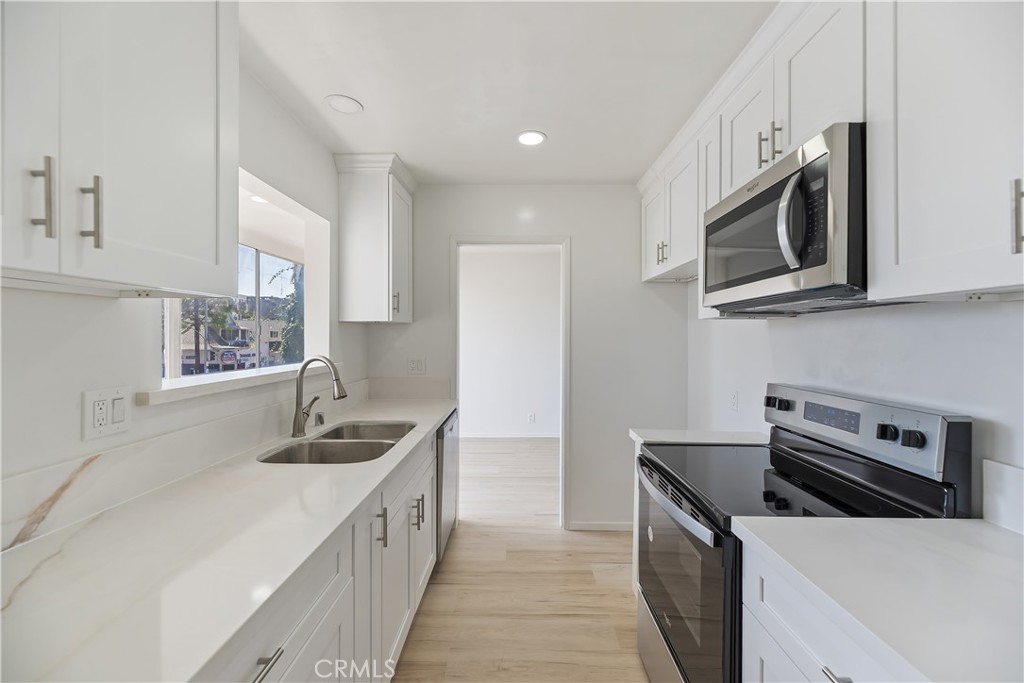 505 Cedar Avenue, Unit 2A Long Beach, CA 90802 - Photo 24 of 71 a kitchen with stainless steel appliances granite countertop a sink stove and microwave