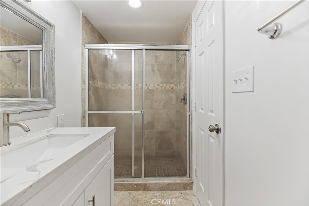 505 Cedar Avenue, Unit 2A Long Beach, CA 90802 - Photo 33 of 71 a bathroom with a shower sink and mirror