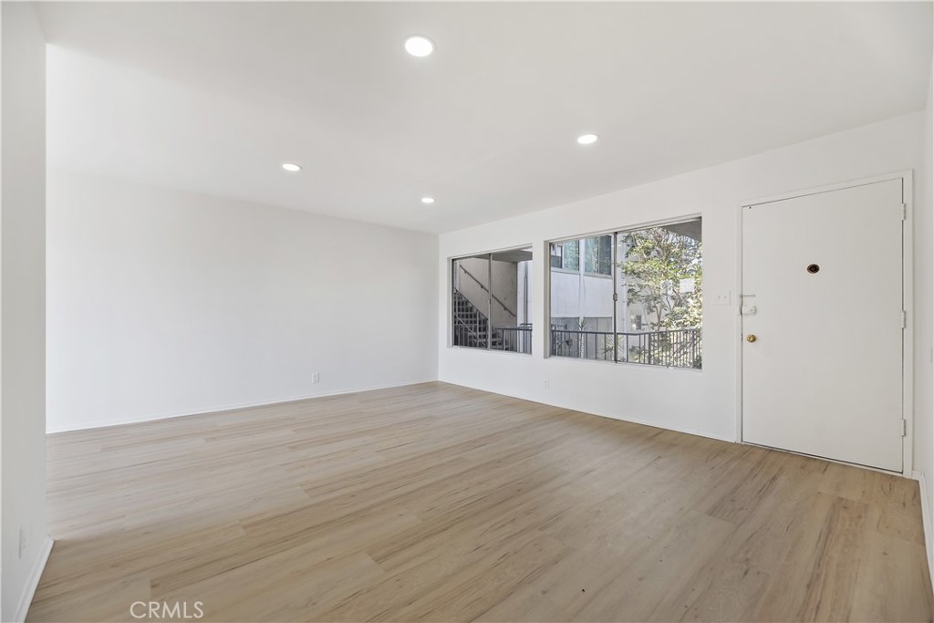 505 Cedar Avenue, Unit 2A Long Beach, CA 90802 - Photo 49 of 71 a view of an empty room with wooden floor and a window