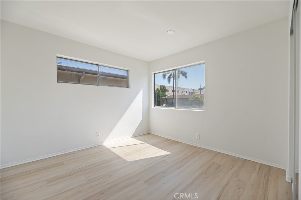505 Cedar Avenue, Unit 2A Long Beach, CA 90802 - Photo 64 of 71 a view of an empty room with wooden floor and a window