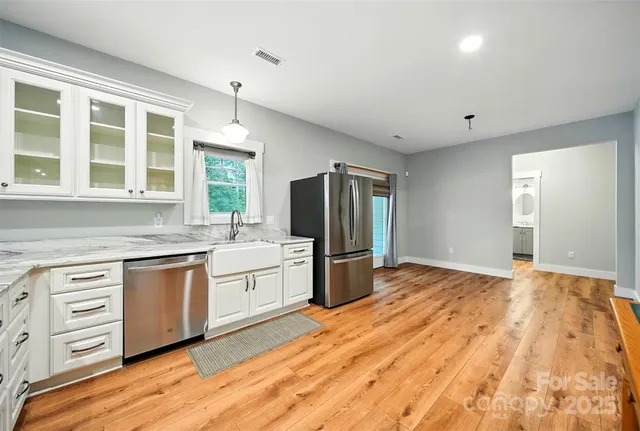 a kitchen with stainless steel appliances granite countertop a stove and a refrigerator