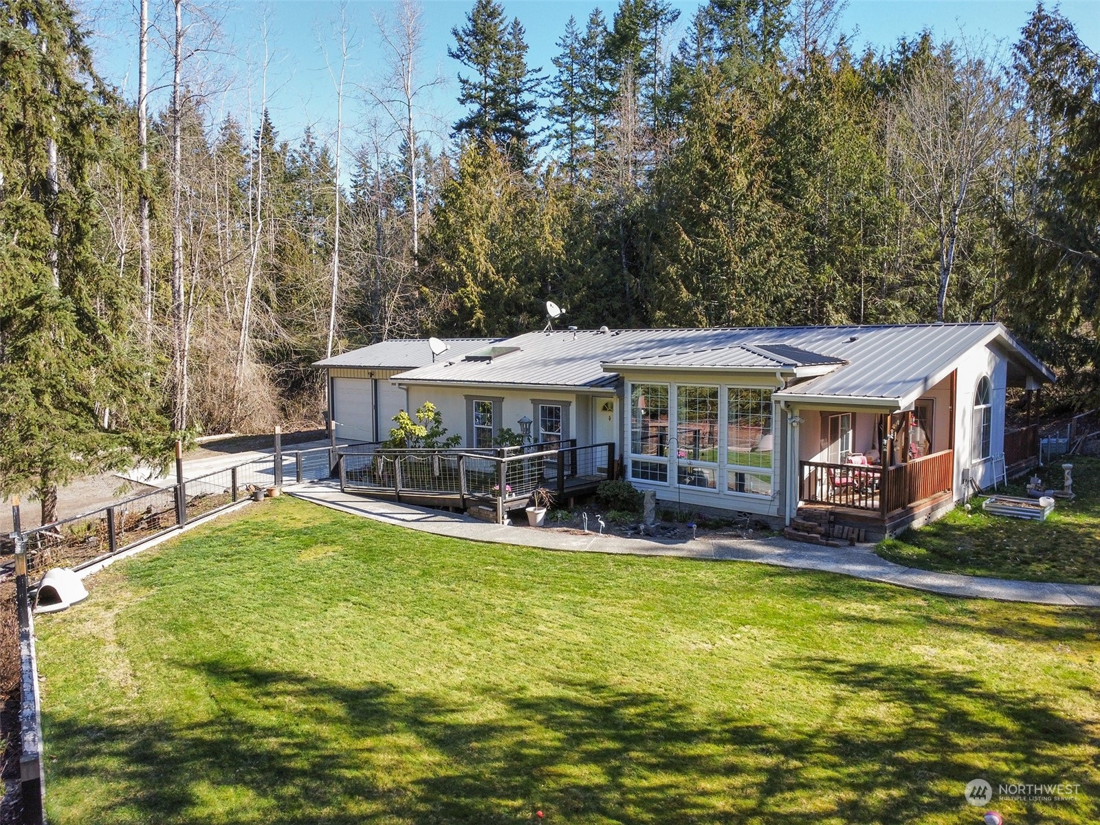 297 Amarillo Road Port Angeles, WA 98362 - Photo 1 of 40 a view of a house with swimming pool and sitting area