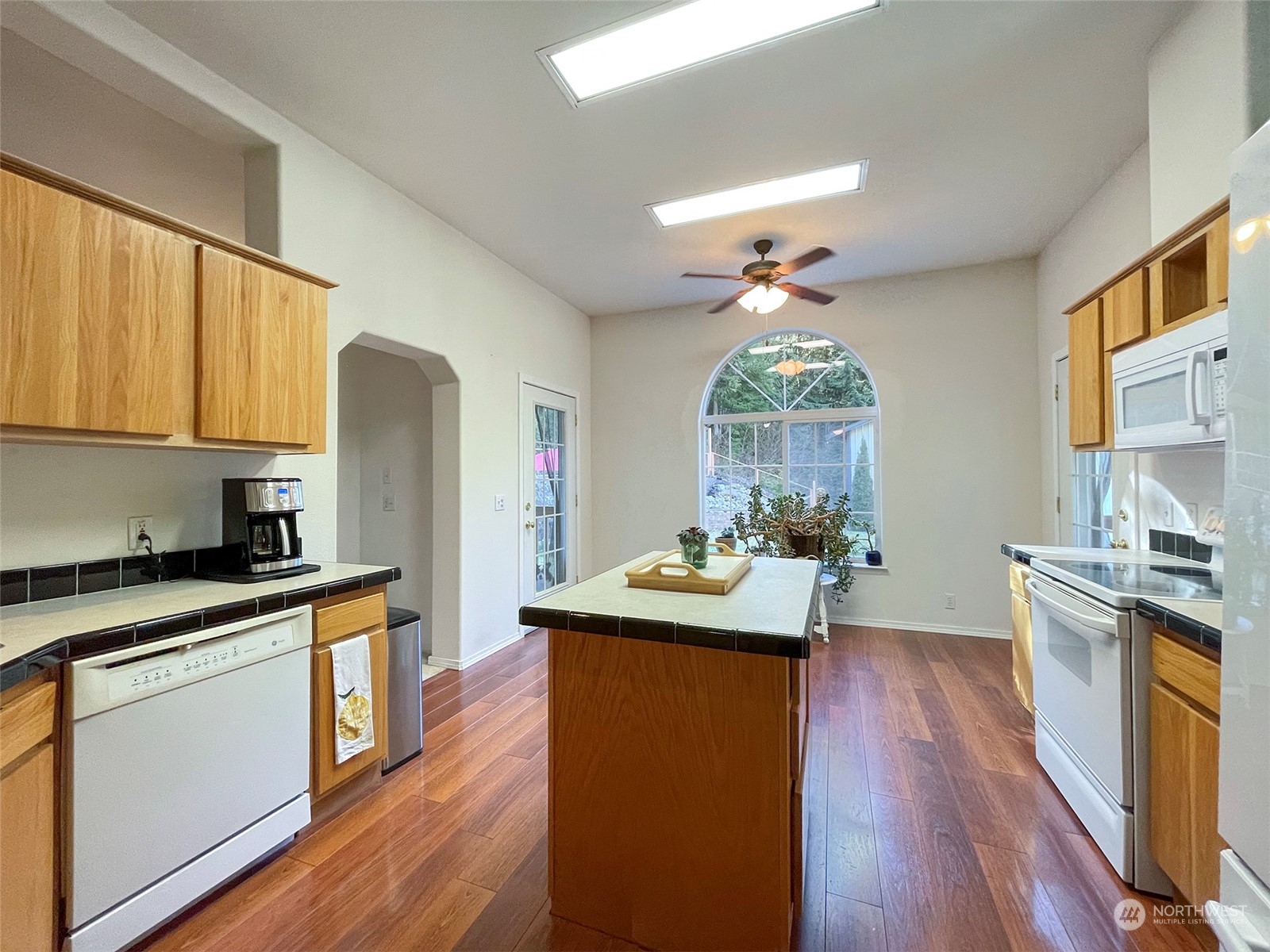 297 Amarillo Road Port Angeles, WA 98362 - Photo 13 of 40 a kitchen with stainless steel appliances wooden floors stove and sink