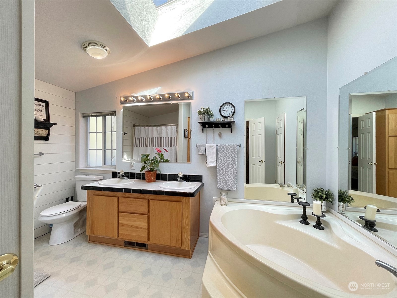297 Amarillo Road Port Angeles, WA 98362 - Photo 20 of 40 a spacious bathroom with a double vanity sink a mirror a toilet and a bathtub