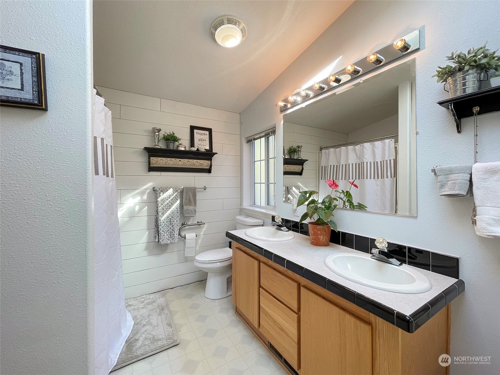 297 Amarillo Road Port Angeles, WA 98362 - Photo 21 of 40 a bathroom with a sink a toilet and a mirror