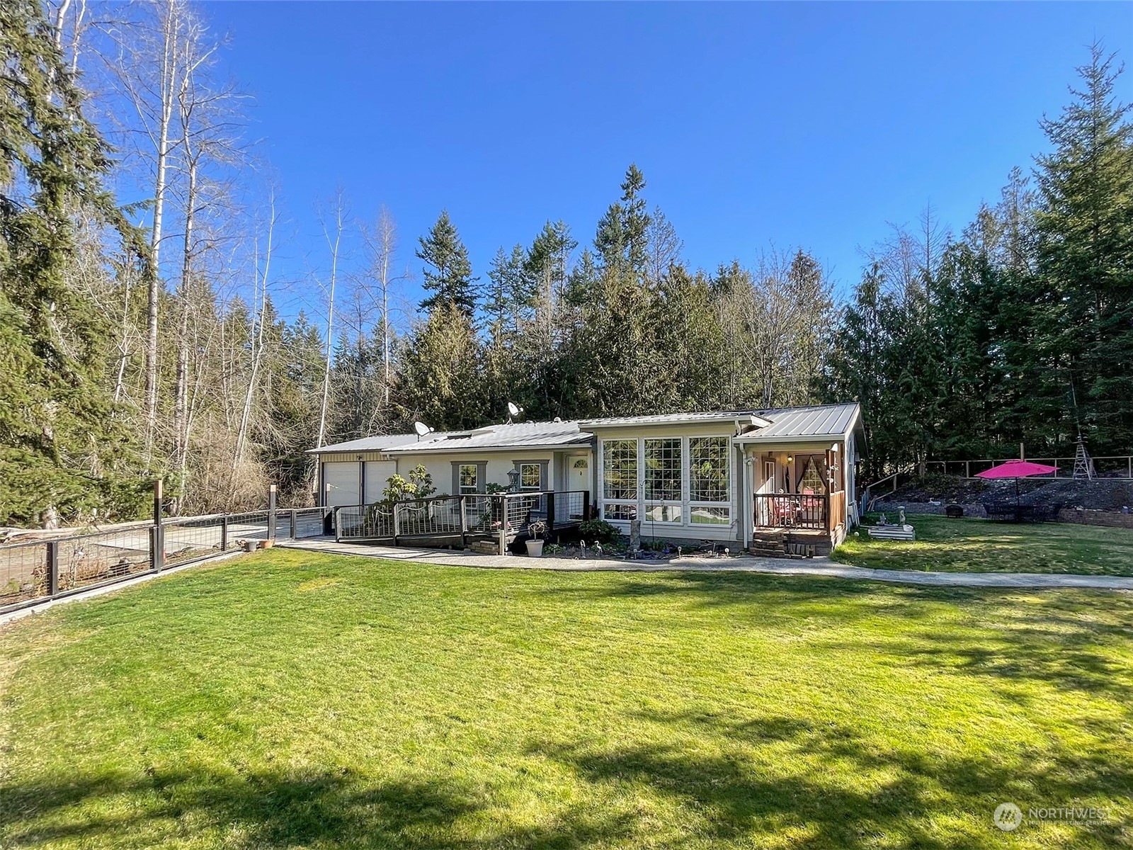 297 Amarillo Road Port Angeles, WA 98362 - Photo 4 of 40 a view of a house with swimming pool and sitting area