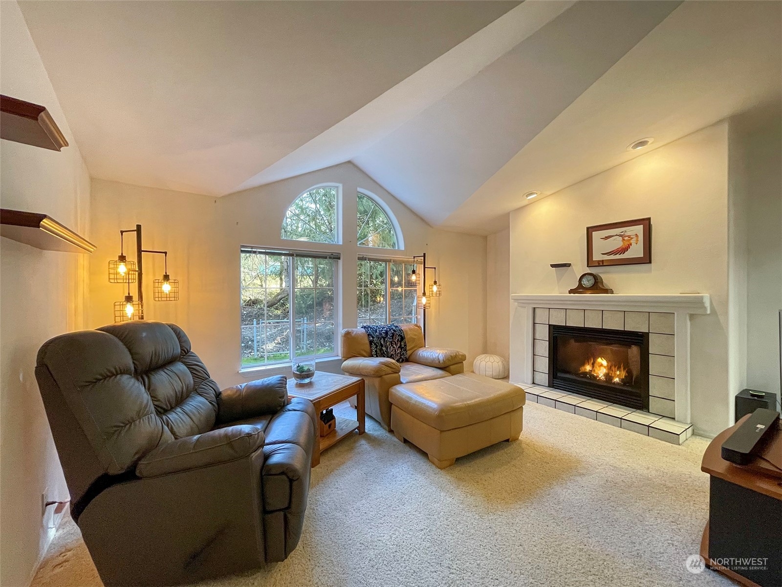 297 Amarillo Road Port Angeles, WA 98362 - Photo 10 of 40 a living room with furniture fireplace and a large window