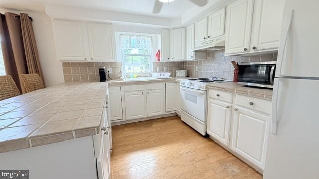 508 Lloyd Street Ocean View, DE 19970 - Photo 12 of 29 a kitchen with white cabinets and white appliances