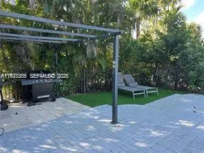 a swimming pool with outdoor seating and yard