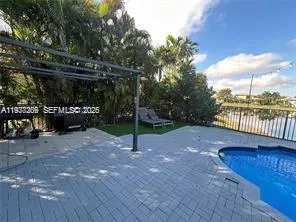 a view of a swimming pool and an outdoor seating
