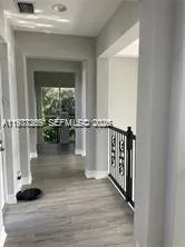 a view of entryway and hall with wooden floor