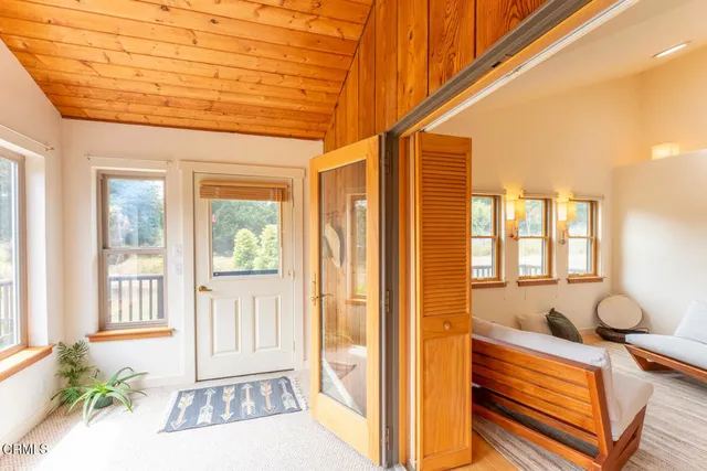 a view of a small space with wooden floor and a window