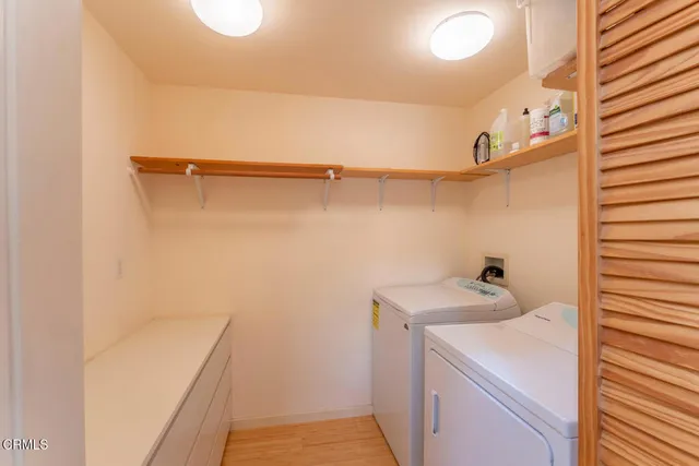 a view of a patio with table and chairs with wooden floor and fence