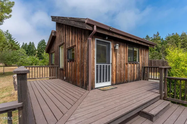 a view of a house with wooden fence