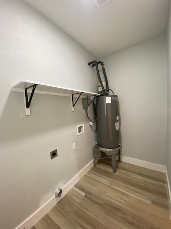 116 Field Street Luling, TX 78648 - Photo 10 of 33 Functional laundry space with a convenient built-in shelf and resilient flooring.