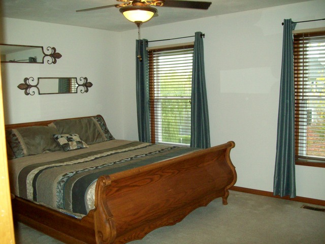 1180 Lewis Road Geneva, IL 60134 - Photo 17 of 25 a bed sitting in a bedroom next to a window