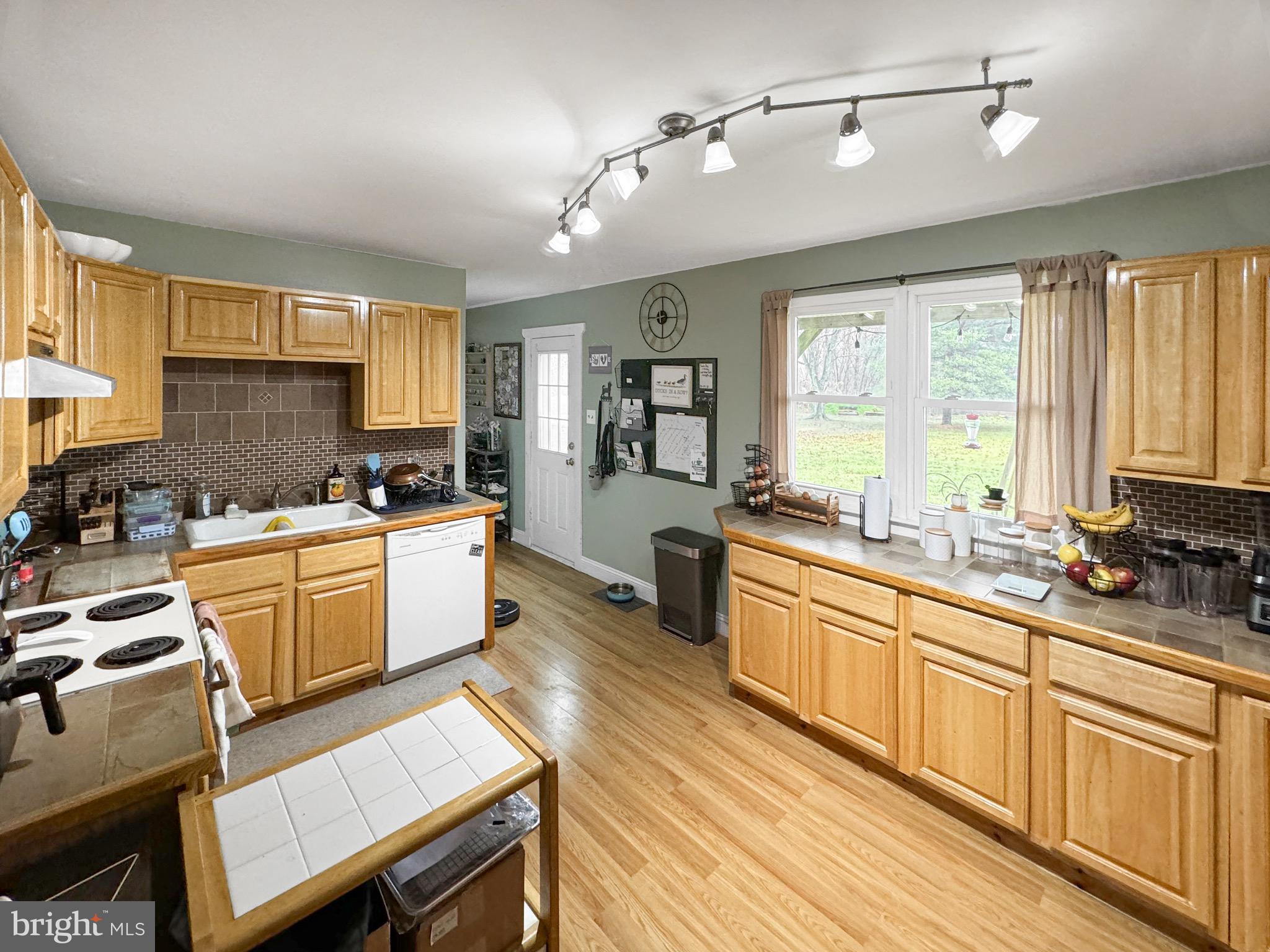 56 Gilbert Road Bordentown, NJ 08505 - Photo 5 of 16 a large kitchen with a window wooden cabinets and stainless steel appliances
