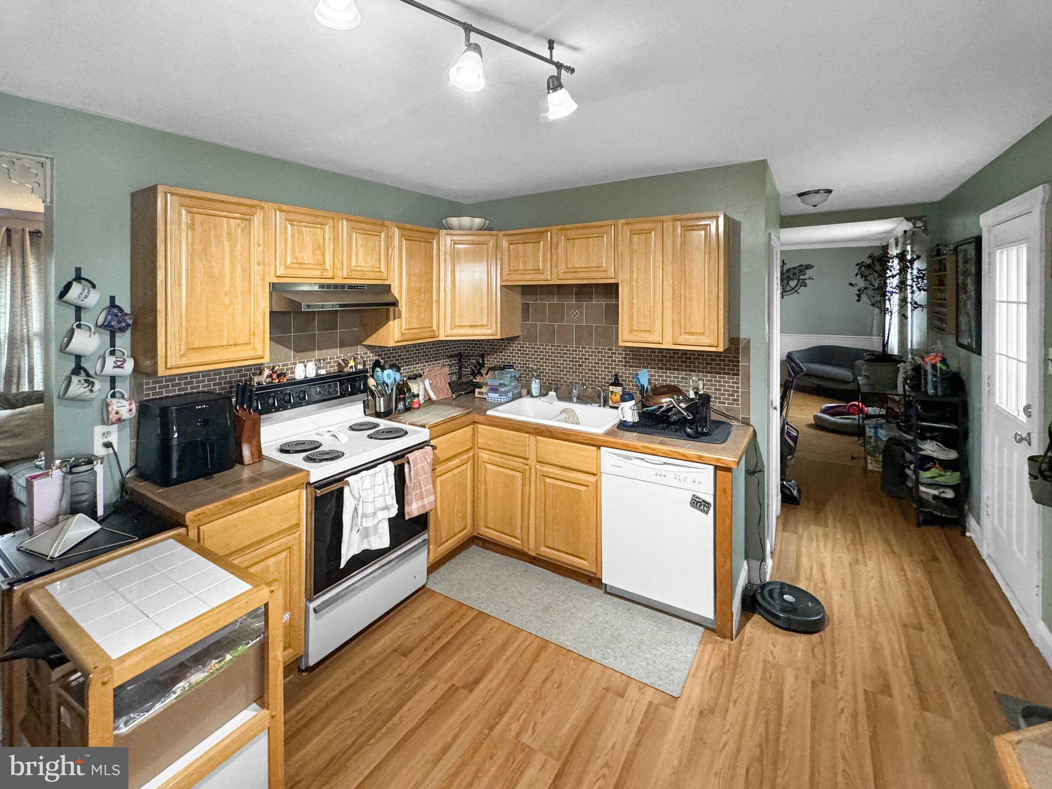 56 Gilbert Road Bordentown, NJ 08505 - Photo 6 of 16 a kitchen with wooden floors appliances cabinets and a center island