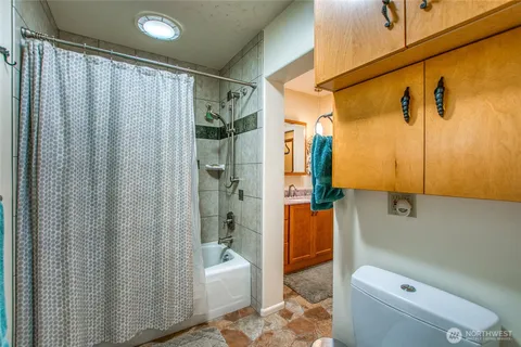 a bathroom with a shower curtain and a sink
