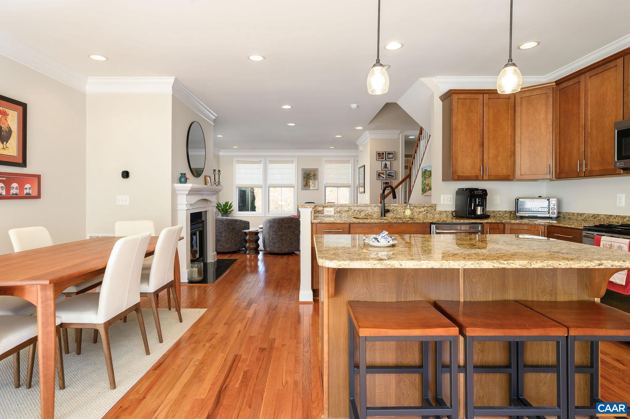 508 Tulip Tree Court Charlottesville, VA 22903 - Photo 11 of 35 a kitchen with stainless steel appliances granite countertop dining table chairs and a wooden floor