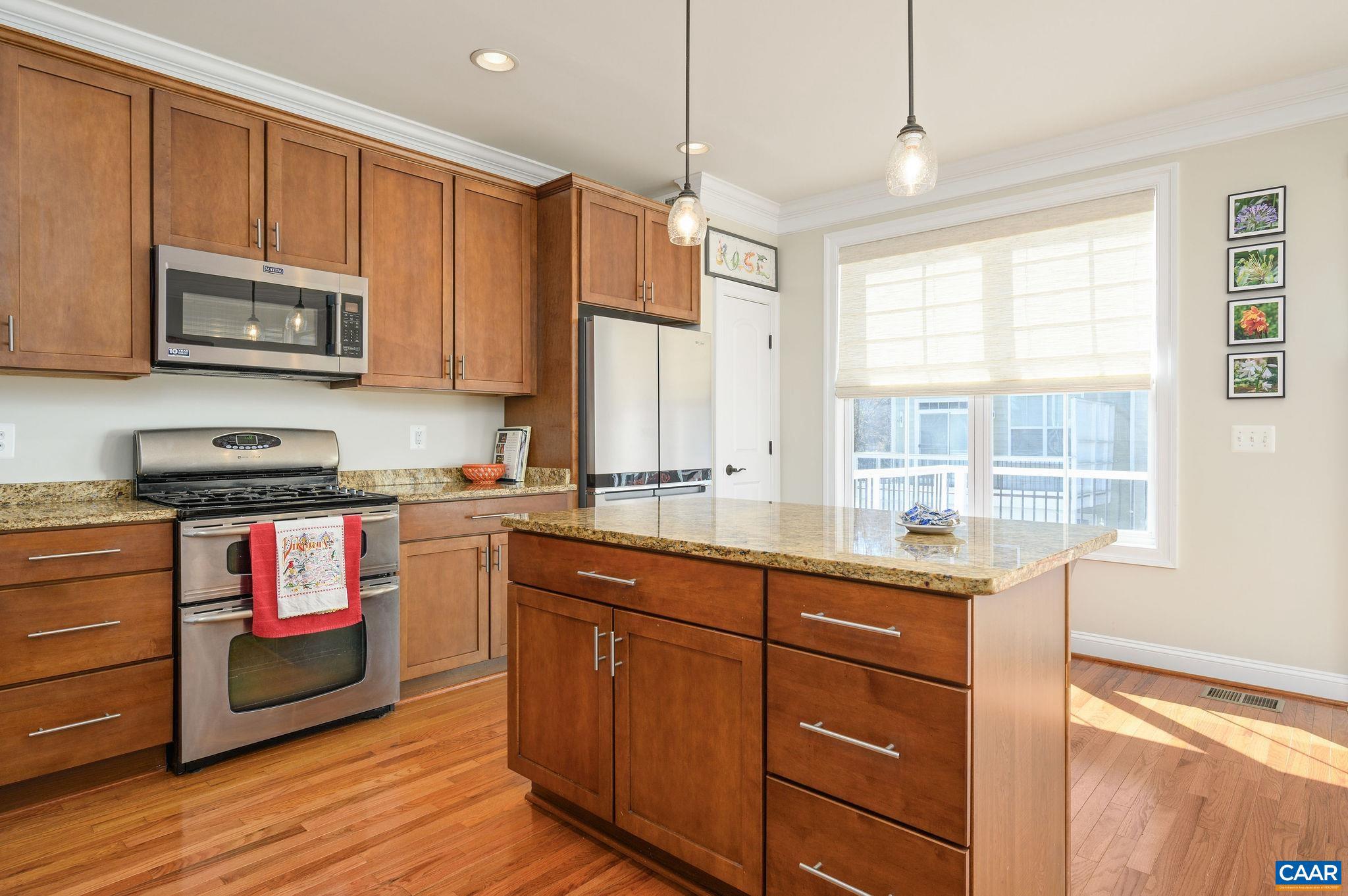 508 Tulip Tree Court Charlottesville, VA 22903 - Photo 13 of 35 a kitchen with stainless steel appliances kitchen island granite countertop a stove a sink and white cabinets