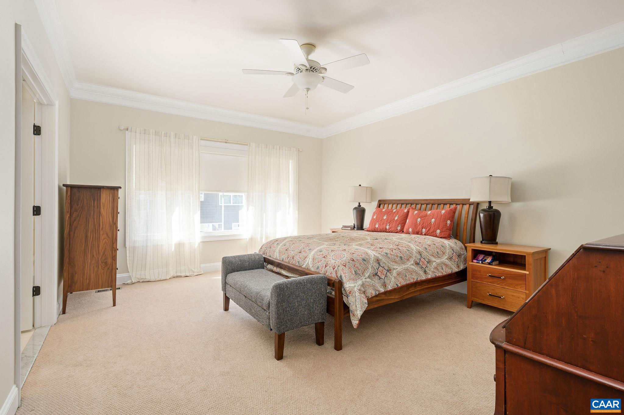 508 Tulip Tree Court Charlottesville, VA 22903 - Photo 16 of 35 a bedroom with a bed and a chandelier