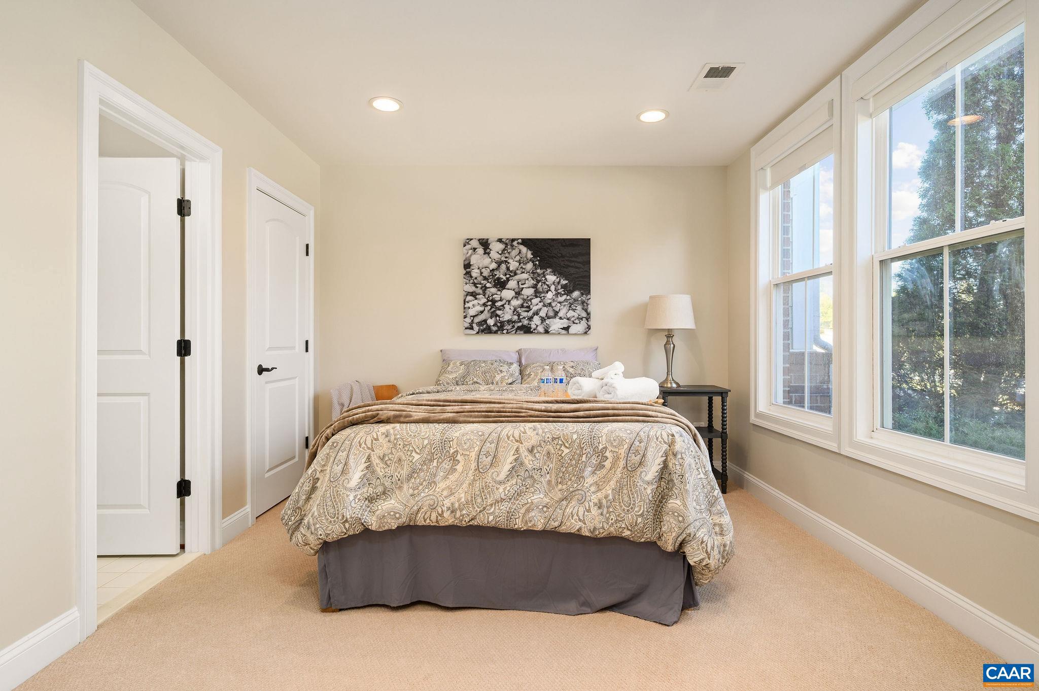 508 Tulip Tree Court Charlottesville, VA 22903 - Photo 3 of 35 a bedroom with a large bed and a large window