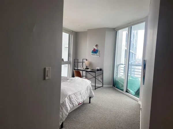 a bed sitting in a bedroom next to a window