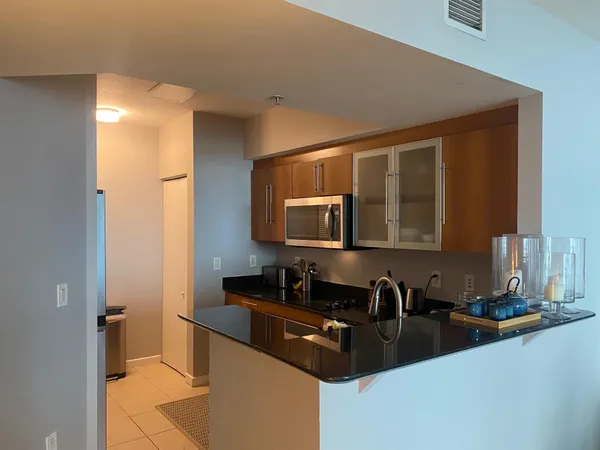 a kitchen with granite countertop a sink and a stove top oven