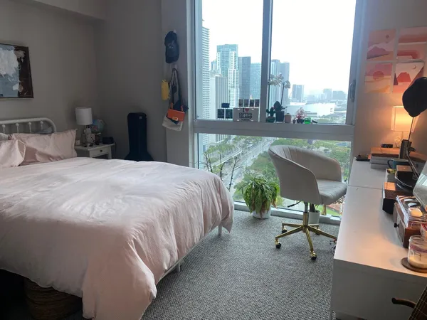 a bed sitting in a bedroom next to a window