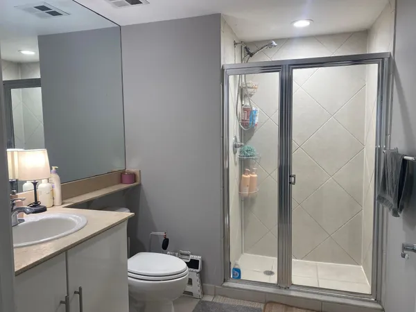 a bathroom with a toilet a sink and shower