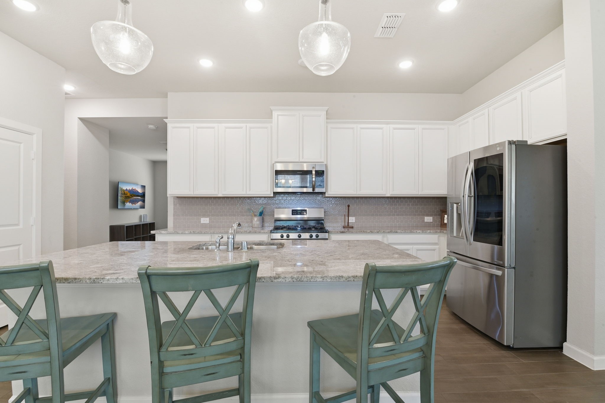 3410 Shockley Lane Rosharon, TX 77583 - Photo 3 of 32 a kitchen with stainless steel appliances granite countertop a table chairs sink refrigerator and microwave