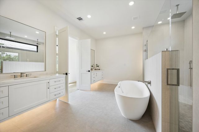 a bathroom with a bathtub and shower