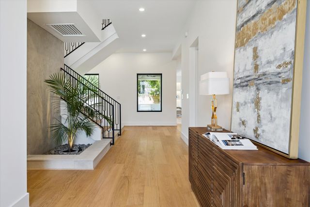 a view of entryway and hall with wooden floor