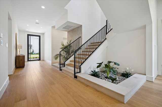 a view of entryway with wooden floor and a potted plant