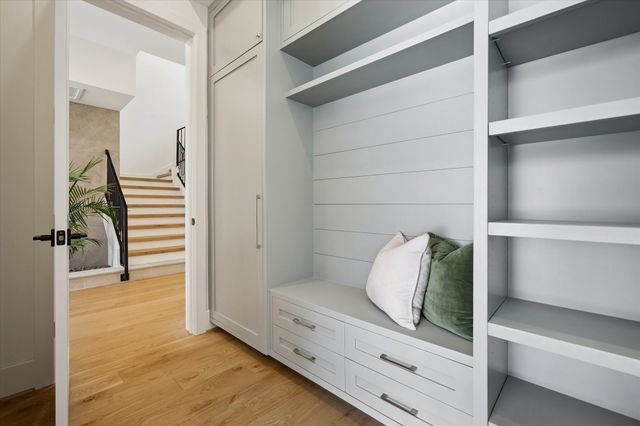 a walk in closet with white walls