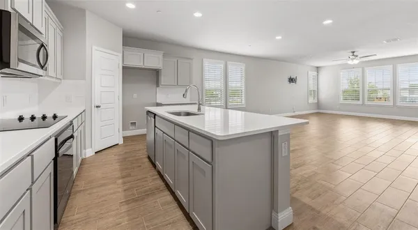 a kitchen with stainless steel appliances granite countertop a sink and a stove