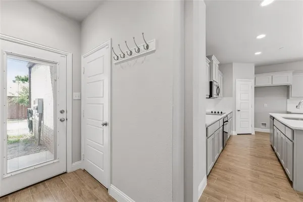 a kitchen with granite countertop a refrigerator and a sink