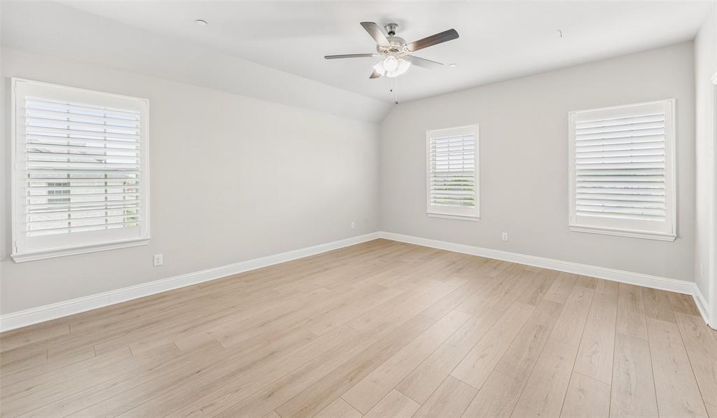 6020 Bursey Road Watauga, TX 76148 - Photo 19 of 33 a view of empty room with wooden floor and fan