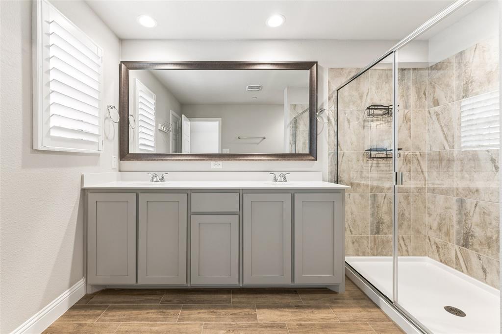6020 Bursey Road Watauga, TX 76148 - Photo 23 of 33 a bathroom with a tub a sink and a large mirror