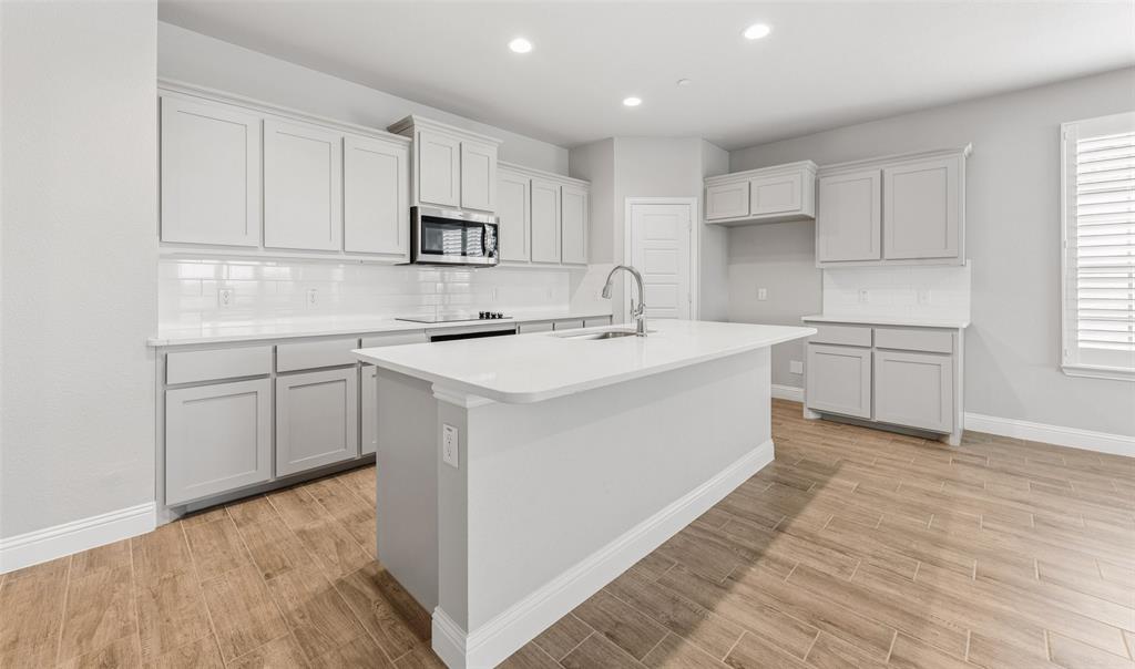 6020 Bursey Road Watauga, TX 76148 - Photo 3 of 33 a kitchen with white cabinets appliances and sink