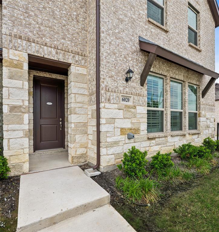 6020 Bursey Road Watauga, TX 76148 - Photo 31 of 33 front view of a brick house with a large window