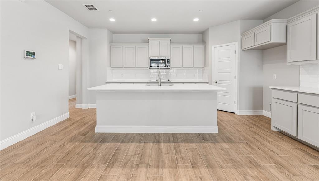 6020 Bursey Road Watauga, TX 76148 - Photo 4 of 33 a view of kitchen with wooden floor and electronic appliances
